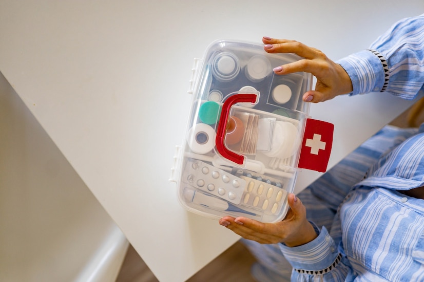 closeup-female-hand-placing-medicament-domestic-first-aid-kit-storage-organization-emergency-supply_226903-2012[1]