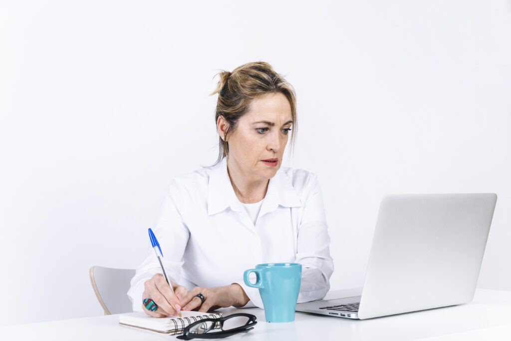 woman-making-notes-near-laptop-1024x683