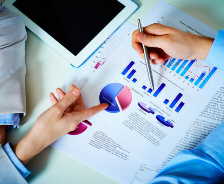 close-up-hands-with-financial-charts-business-meeting (1)