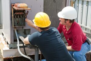 two-men-repairing-ac-unit