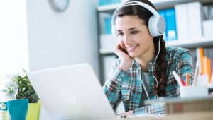Girl-with-Headphones-Using-Laptop-Listening-to-Podcast-Feature-Image
