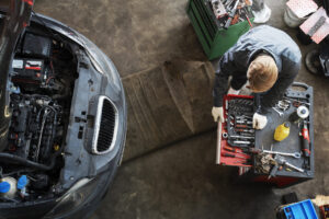 top-view-man-repairing-car_Easy-Resize.com